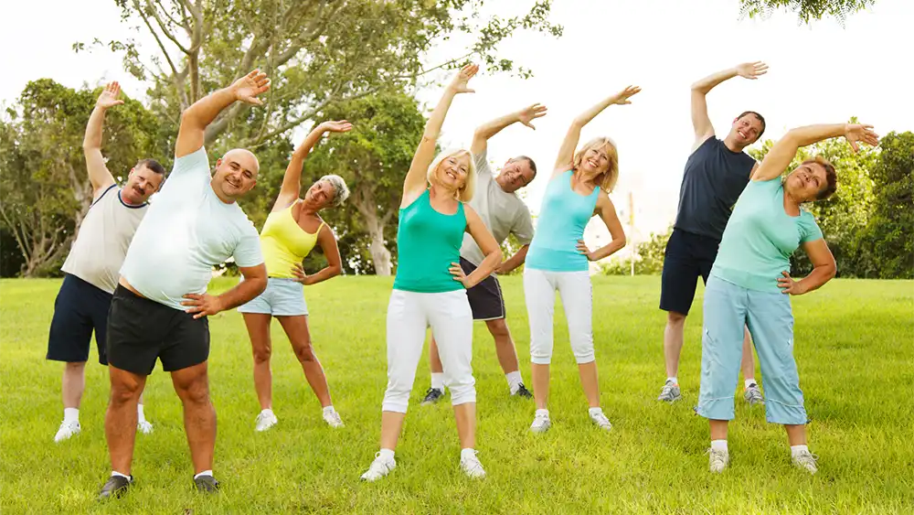 A group of people exercise outdoors