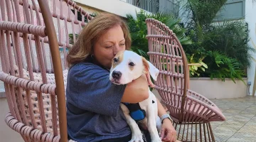 Anna Proleika with an adopted dog on her lap.