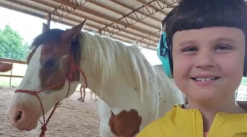 Cal spending time with a horse.