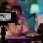 Mom Influencers, momfluencers photo. A video camera in the foreground with a blurred background