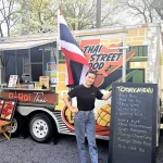 The proud owner of the A-Roi Thai Food Truck, Pat Tantikul, serves Thai street food with a smile.