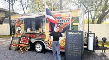 The proud owner of the A-Roi Thai Food Truck, Pat Tantikul, serves Thai street food with a smile.
