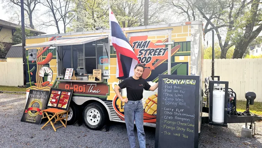 Pat Tantikul, the proud owner of the A-Roi Thai Food Truck, serves Thai street food with a smile.