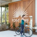 A woman in the Point Hope community stops to fill her water bottle while biking.