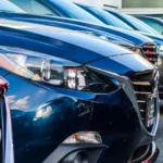 Cars, SUVs and trucks in a parking lot.