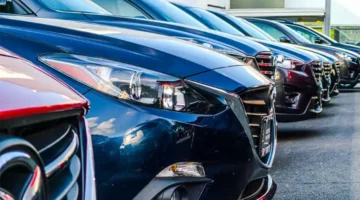 Cars, SUVs and trucks in a parking lot.