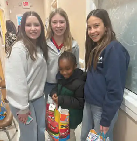 Pictured (from left) are Cate, Miranda and Jessie, whose outreach project benefitted the Navigation Center, which helps homeless people find jobs, get into rehab and get their kids back into school.