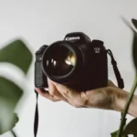 Photography - a photographer holding a camera. Photo by Lilly Rum on Unsplash.