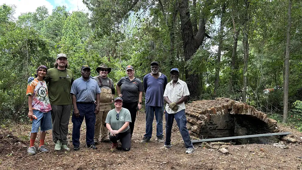 Participants who did work arounf the empty, unmarked, brick tomb on the edge of the Phillips Community in Mount Pleasant, SC.