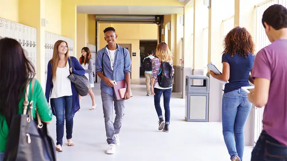 High school students walking through a hallway