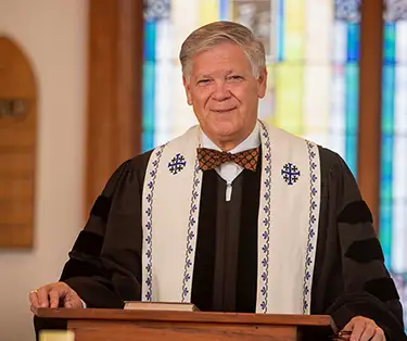 Photo of Rev. Mike Fitze of New Wappetaw Presbyterian Church standing at the pulpit.