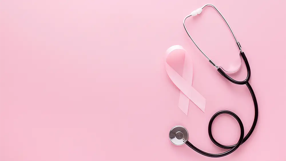 Breast Cancer Awareness graphic. A pink ribbon, stethoscope with pink ear tubes on a pink background