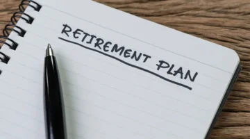 Photo of a pen and a notebook labeled "Retirement Plan"