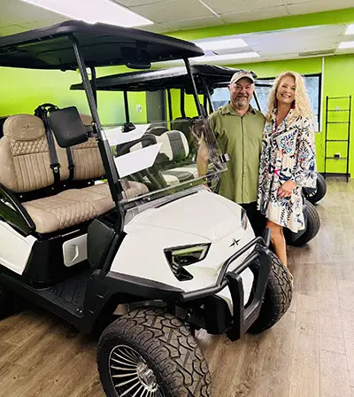 Owners Chad Shores and Andrea Leary pose next to one of their popular-selling LSVs at Rad Rydz. Photo provided.