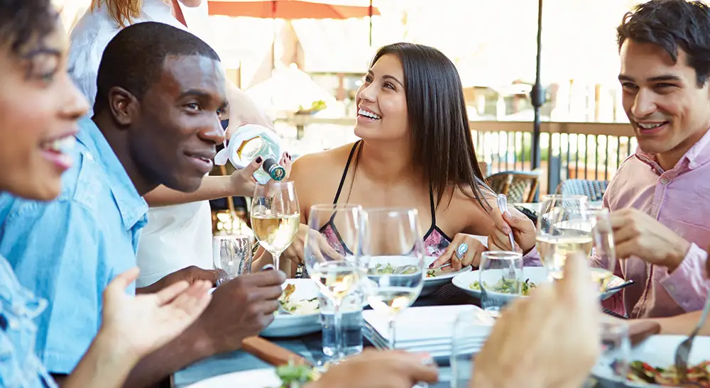 Friends enjoying a meal at a Mount Pleasant restaurant.