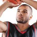BOYS BASKETBALL: A male student about to take a shot with a basketball