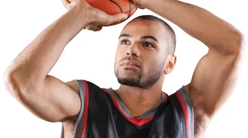 BOYS BASKETBALL: A male student about to take a shot with a basketball