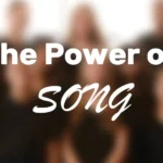 HEADER: The Power of Song, with blurred singers in the background